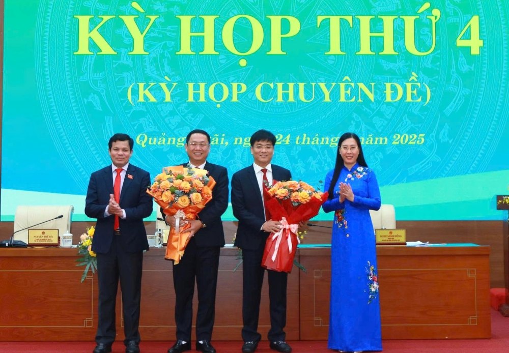 Quang Ngai 지방 당 위원회 서기 Bui Thi Quynh Van이 두 명의 새로운 인민위원회 부위원장에게 꽃을 전달하며 축하하고 있습니다. 사진: VGP