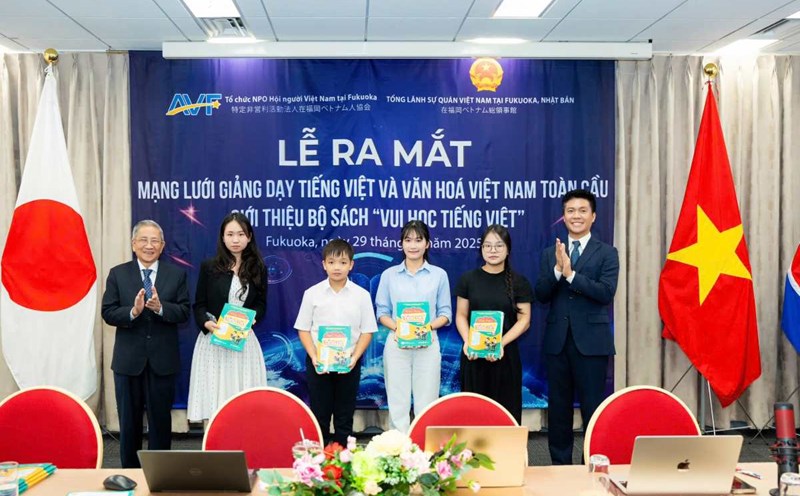 Giving books to students at the launching ceremony of the Global Vietnamese and Cultural Teaching Network. Photo: State Committee for Overseas Vietnamese
