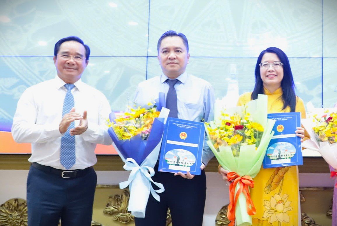 Chủ tịch UBND TPHCM Nguyễn Văn Được trao quyết định cho ông Phạm Huy Bình (giữa) và bà Nguyễn Thị Ánh Hoa.  Ảnh: Ngô Tùng