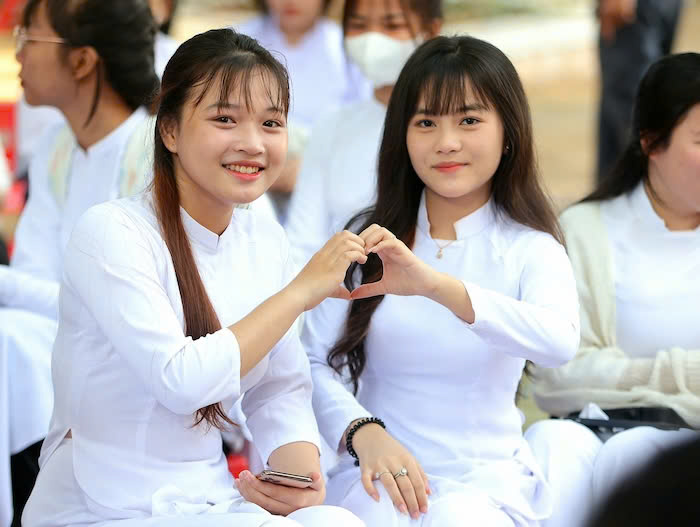Nu sinh Tran Kim Phung (trai) va Nguyen Pham Thao Vy (phai), hoc sinh lop 10C1, Truong THPT Vinh Thanh (TP Can Tho) hao huc tham du Le khai giang nam hoc 2025 - 2026. Anh: My Ly