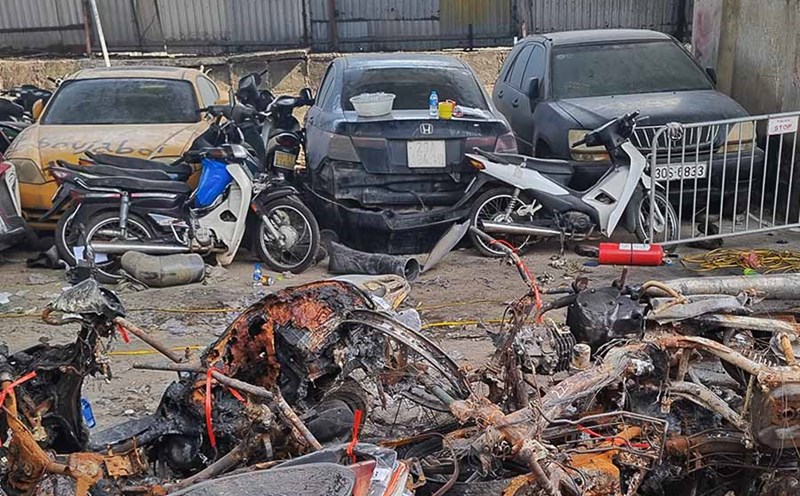 There are also cars and motorbikes parked at this parking lot.