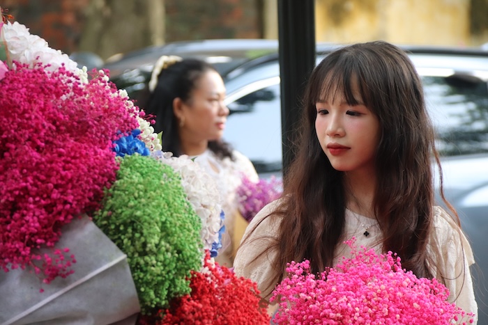 Tourists take photos on Phan Dinh Phung Street. Photo: Nguyen Linh