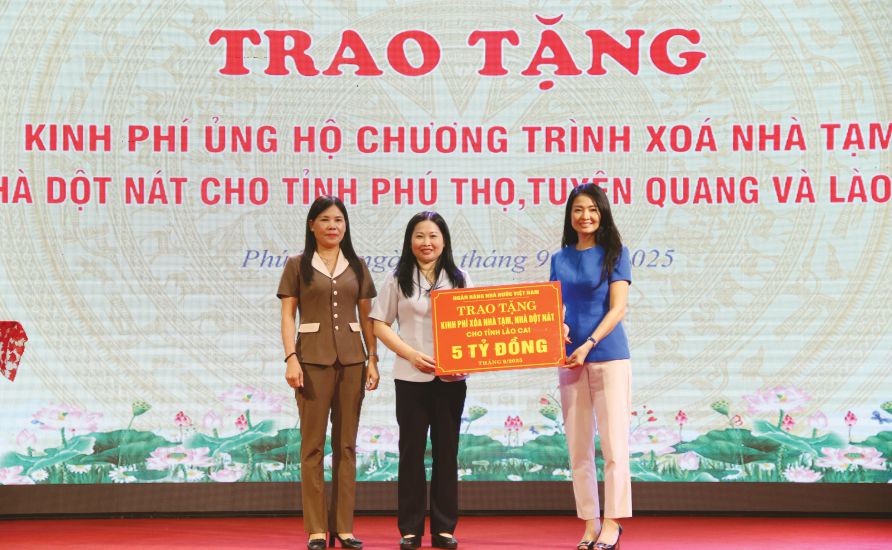 Mme Nguyen Khanh Chi - Vice-presidente permanente du syndicat de la Banque d'Etat du Vietnam remet un soutien financier a la province de Lao Cai. Photo : Tran Minh