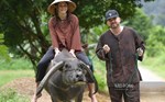 Why do Western tourists come to Ninh Binh with mud and footwork to graze buffaloes and grow rice?