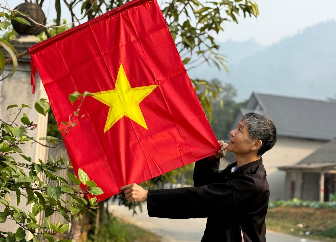 People hang national flags in front of their houses to express national pride. Photo: To Dung.