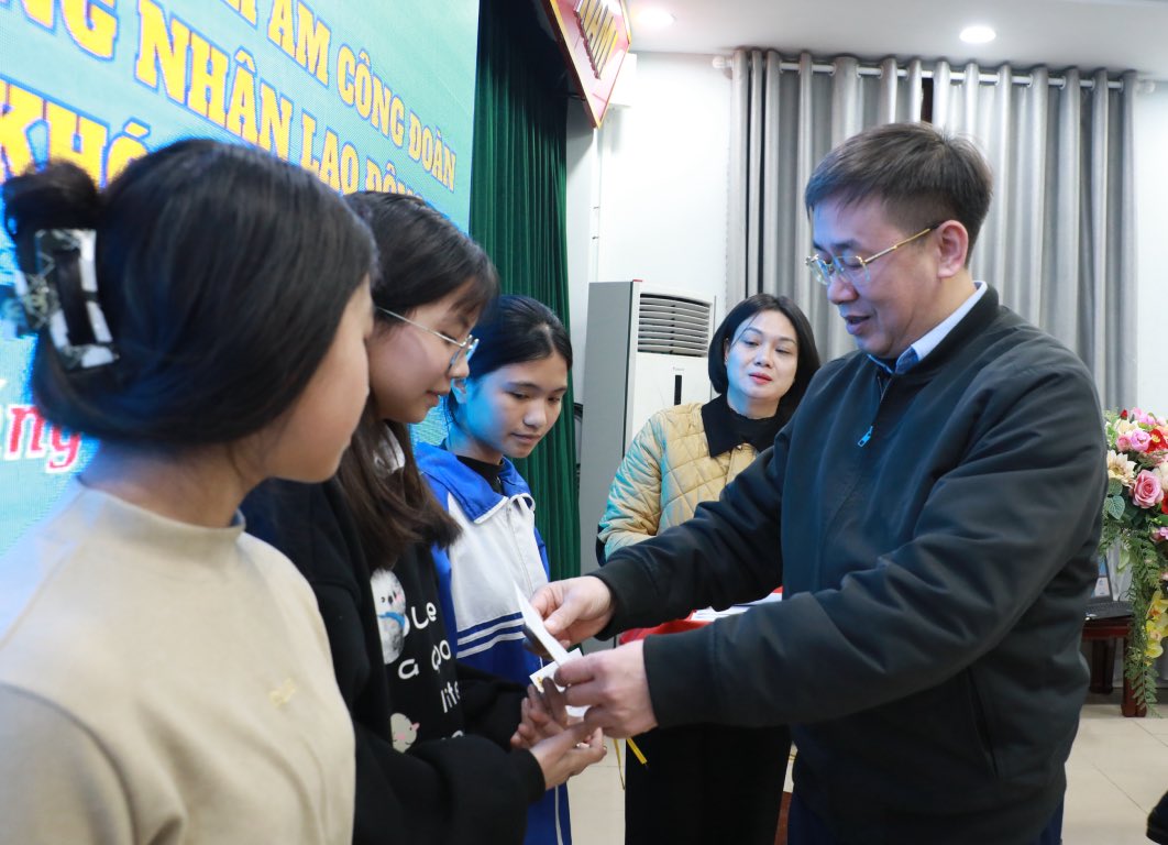 Chu tich Lien doan Lao dong tinh Bac Ninh Thach Van Chung trao hoc bong toi cac em hoc sinh. Anh: 