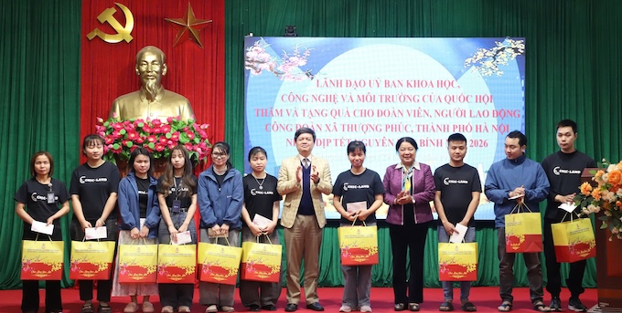 Mr. Ta Dinh Thi - Deputy Chairman of the National Assembly's Committee for Science, Technology and Environment (7th from the left) and Ms. Nguyen Thi Thu Thuy - Vice President of the Hanoi Labor Federation (4th from the right) - present Tet support gifts to union members and workers in Thuong Phuc commune. Photo: Manh Quan