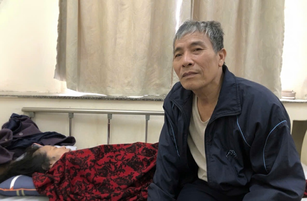 Mr. Tran Van Phuc has been on duty by the hospital bed since Ms. Nguyen Thi Tuyen had both kidney failure and stroke. Photo: Quynh Chi