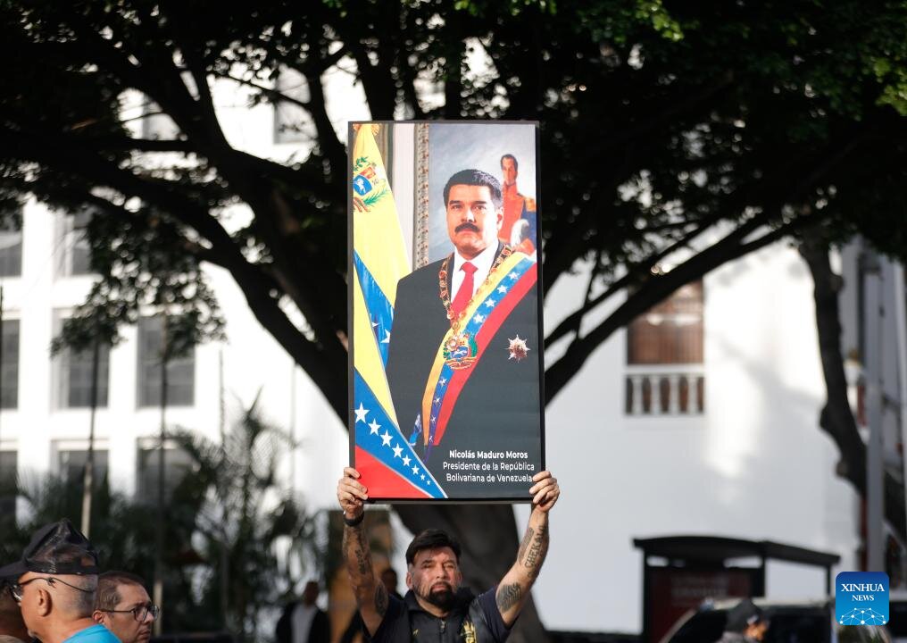 A person holding a photo of President Nicolas Maduro in Caracas, Venezuela on January 3, 2026. Photo: Xinhua
