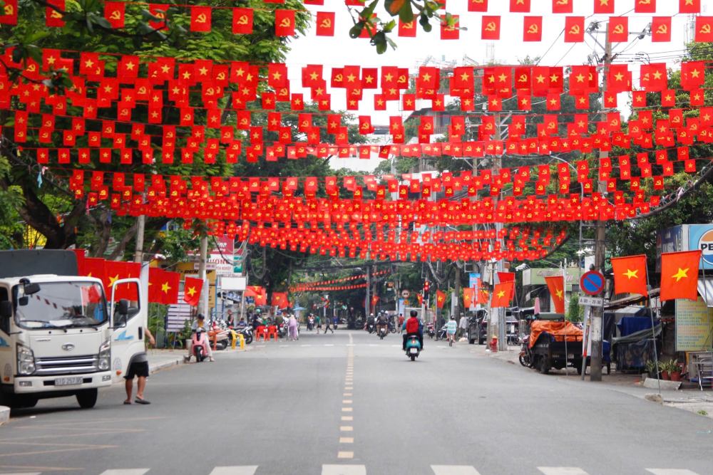 Cờ đỏ sao vàng tung bay rực rỡ trên tuyến đường Thanh Đa, phường Bình Quới. Ảnh: Thái Bảo