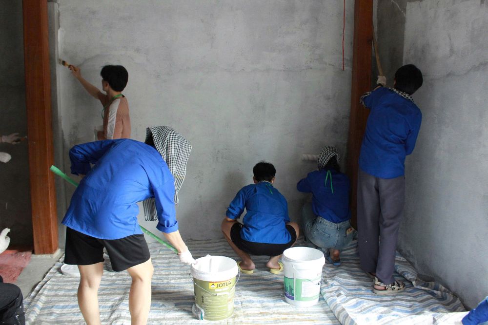 Tình nguyện viên hỗ trợ sơn sửa, chỉnh trang nhà ở cho hộ dân khó khăn tại địa phương. Ảnh: Trung Huyền