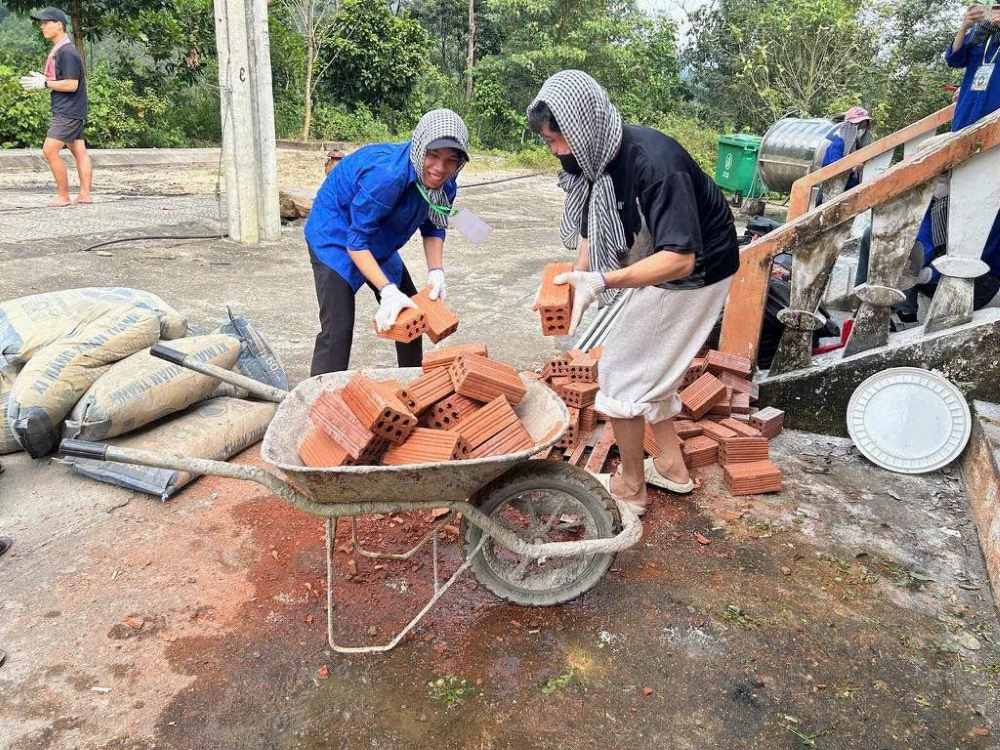 Sinh viên tình nguyện miệt mài sơn sửa công trình dân sinh trong những ngày cận Tết. Ảnh: Trung Huyền