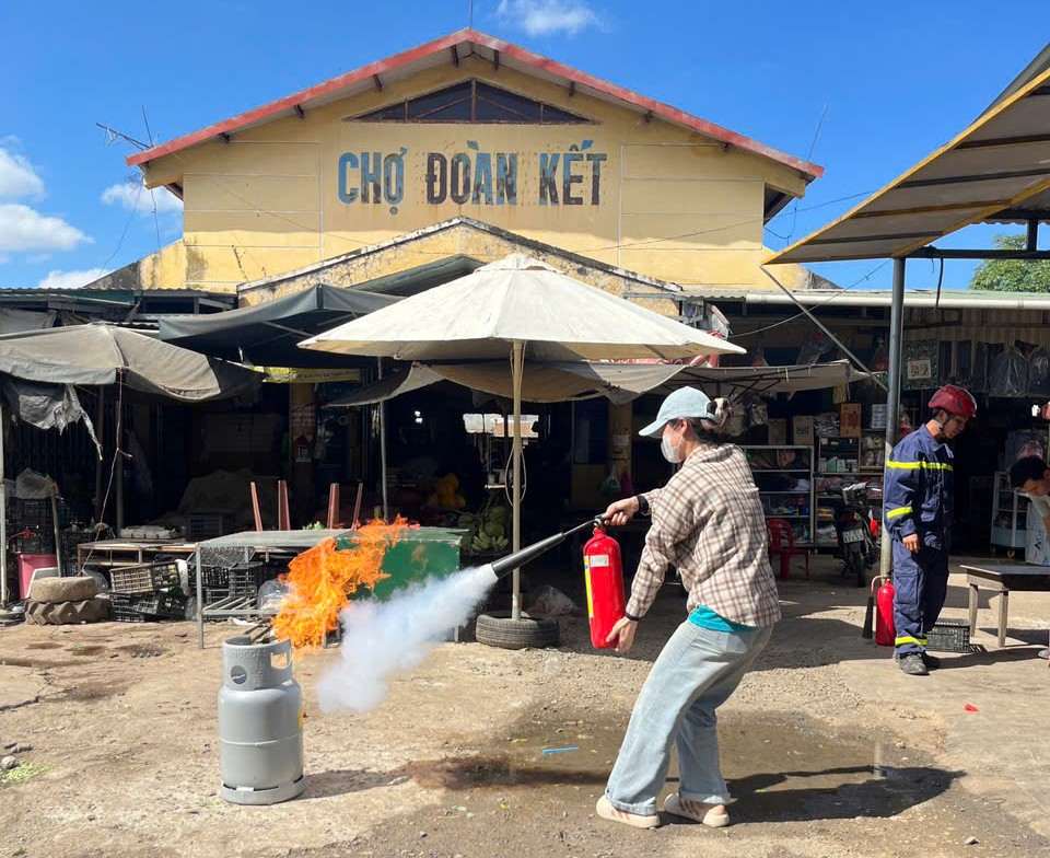 Small traders in Hoa Phu commune (Dak Lak province) are guided on fire prevention and fighting skills. Photo: Bao Trung
