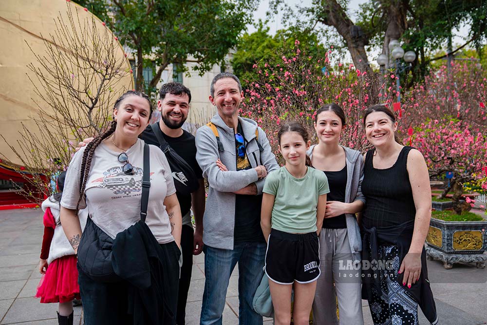 Gia đình du khách thích thú ngắm các loại hoa trưng Tết của người Việt. Ảnh: Hồng Quân