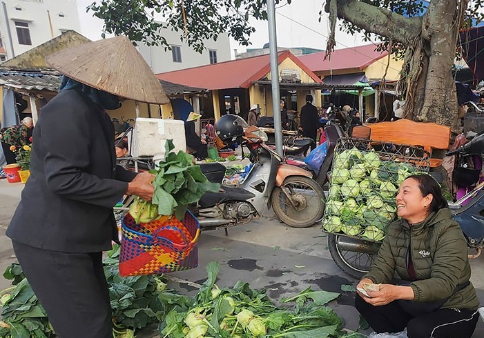 Cả người bán và người mua đều mang tâm trạng vui vẻ trong phiên chợ ngày cuối năm. Ảnh: Diệu Anh