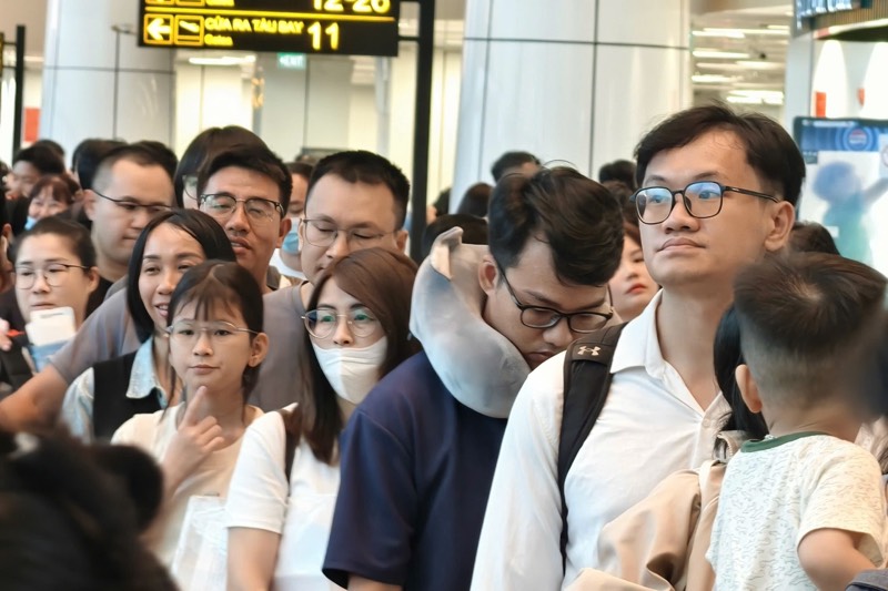 Dòng người nối đuôi nhau làm thủ tục soi chiếu. Ảnh: Anh Tú