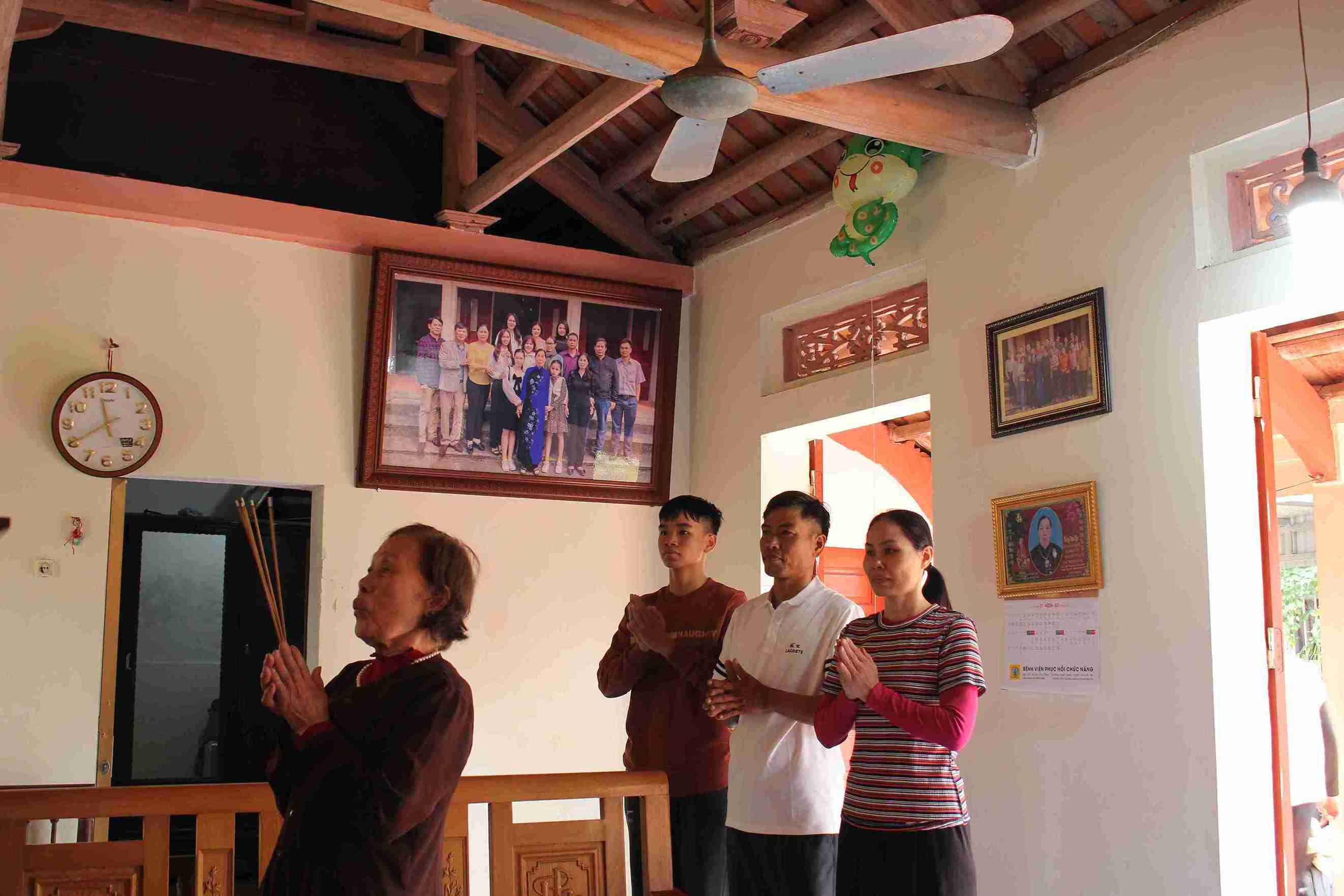 Chị Đào Thị Thinh cùng mẹ, em trai và con trai thắp hương gia tiên trong ngày sum họp cuối năm.