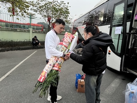 Hai bó hoa ly sẽ theo những công nhân này về quê ở Thanh Hóa trên chuyến xe Công đoàn. Ảnh: Kiều Vũ
