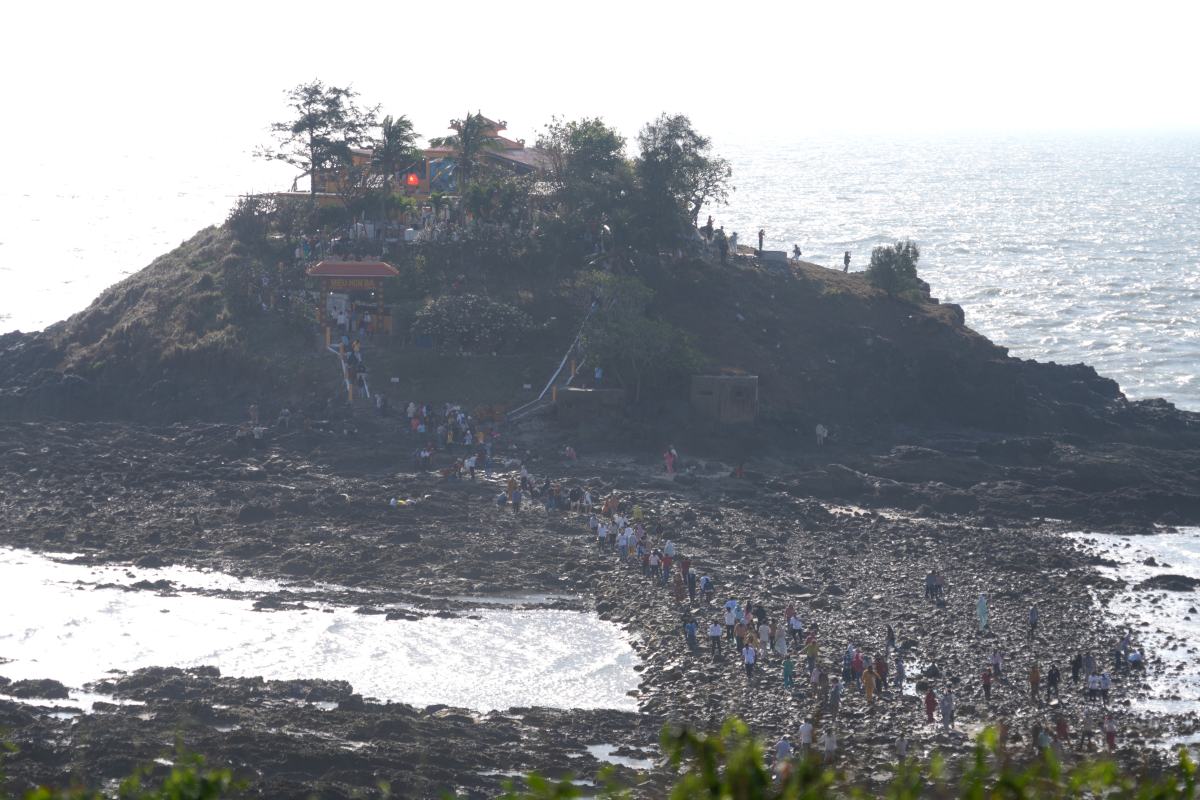 Thousands of people cross the sea on a jagged stone road, offering incense to pray for peace at Hon Ba temple. Photo: Thanh An