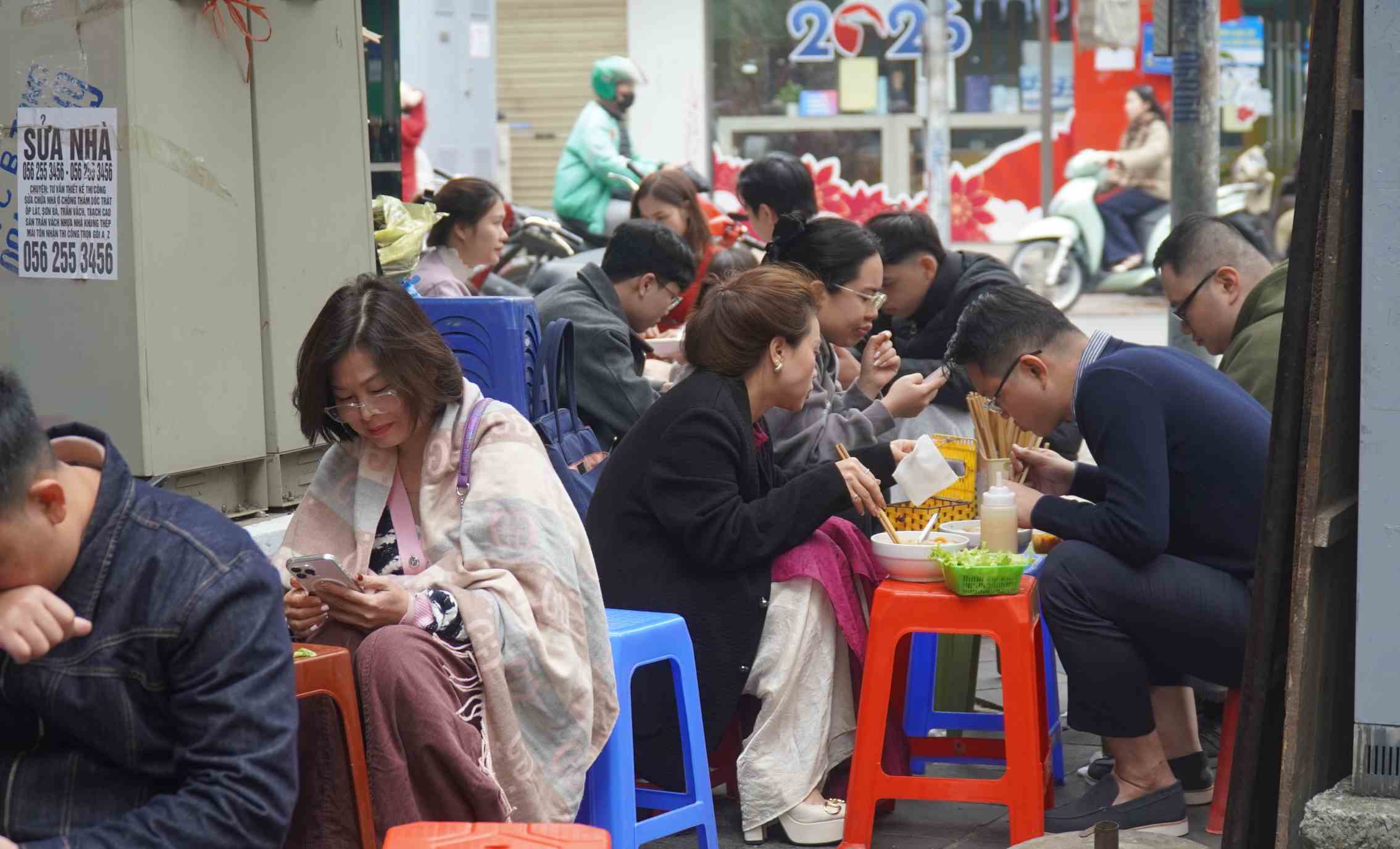 Người dân tranh thủ thưởng thức bún nóng hổi trong những ngày đầu năm. Ảnh: Minh Vũ
