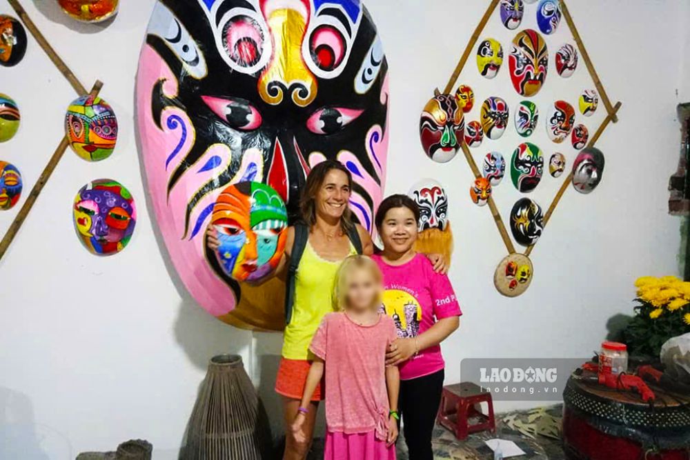 Du khách quốc tế thích thú chiêm ngưỡng và lựa chọn những chiếc mặt nạ truyền thống làm quà lưu niệm. Ảnh: Thanh Huyền