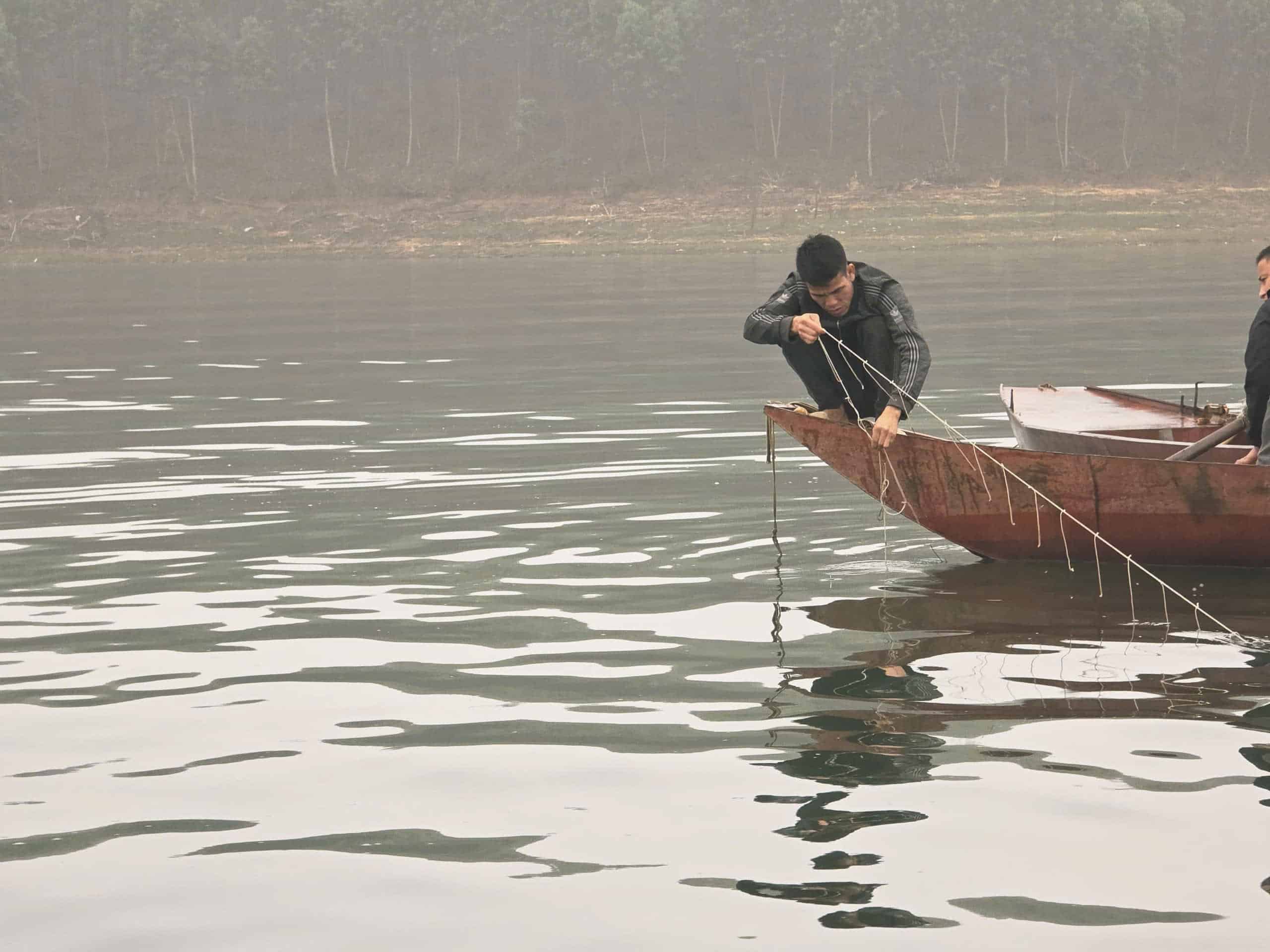 Các lực lượng đưa thi thể cháu M lên thuyền. Ảnh: Văn Đức.
