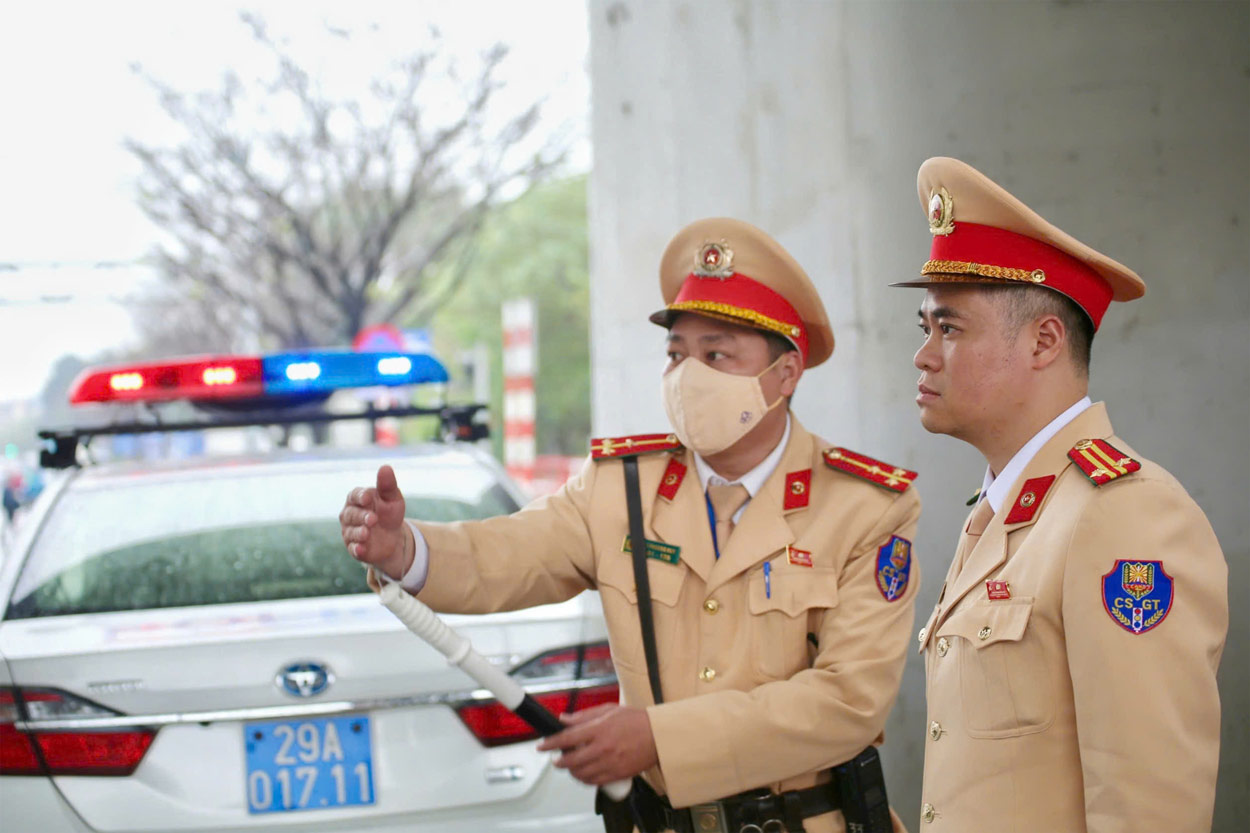 Trung tá Đào Việt Long - Phó trưởng Phòng CSGT Hà Nội (bên phải) chỉ đạo công tác bảo đảm TTATGT. Ảnh: Tô Thế