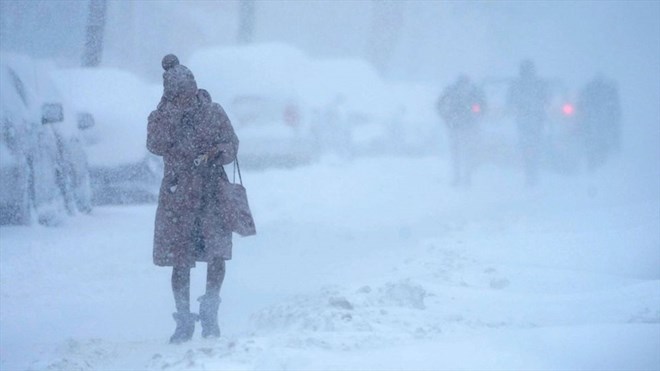 A woman spinning in the middle of a white snowstorm in Jersey City, Jersey State, USA, February 1, 2021. Photo: AFP