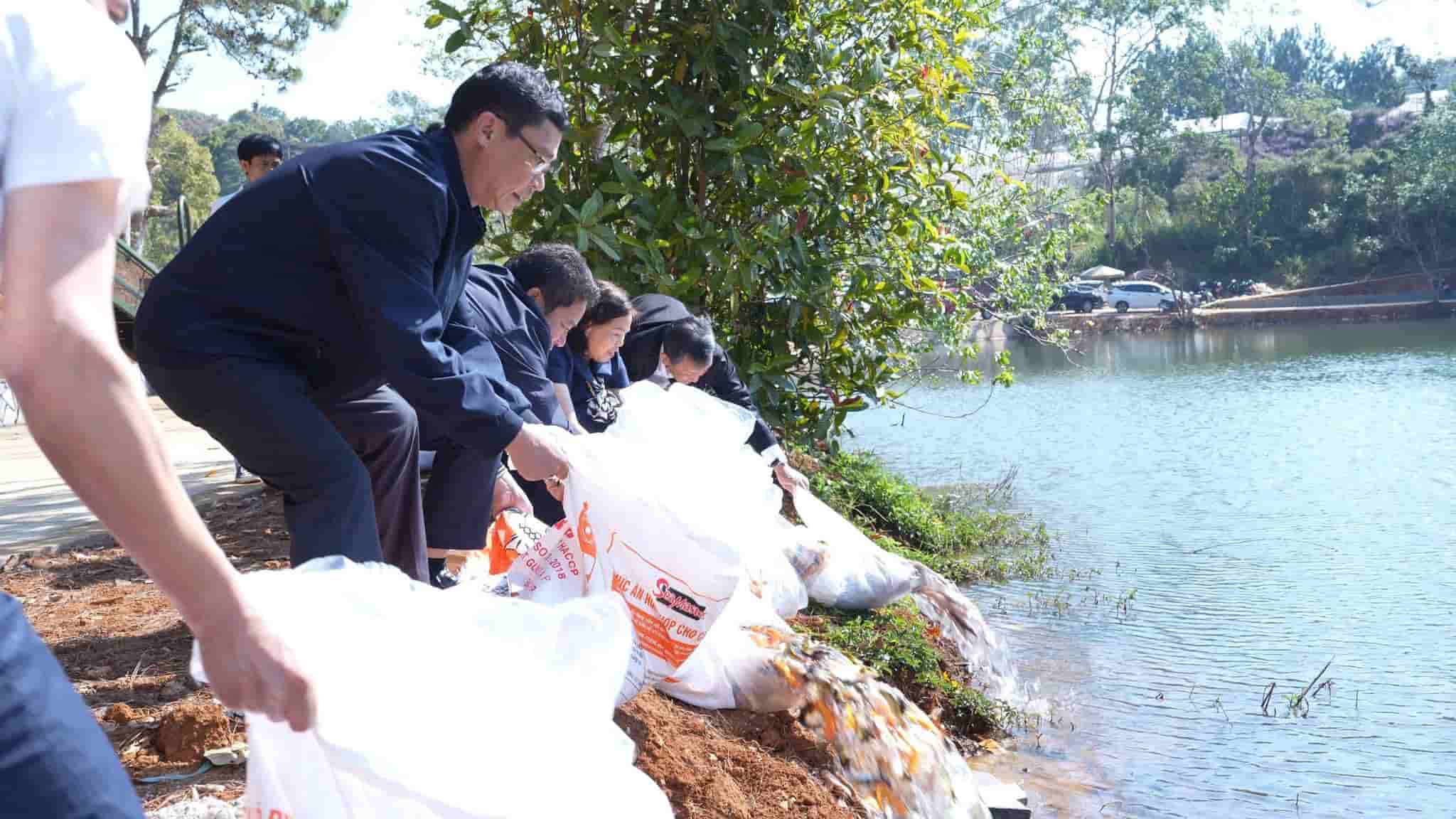 Thả cá giống về hồ Đăkke. Ảnh: Thăng Phạm 