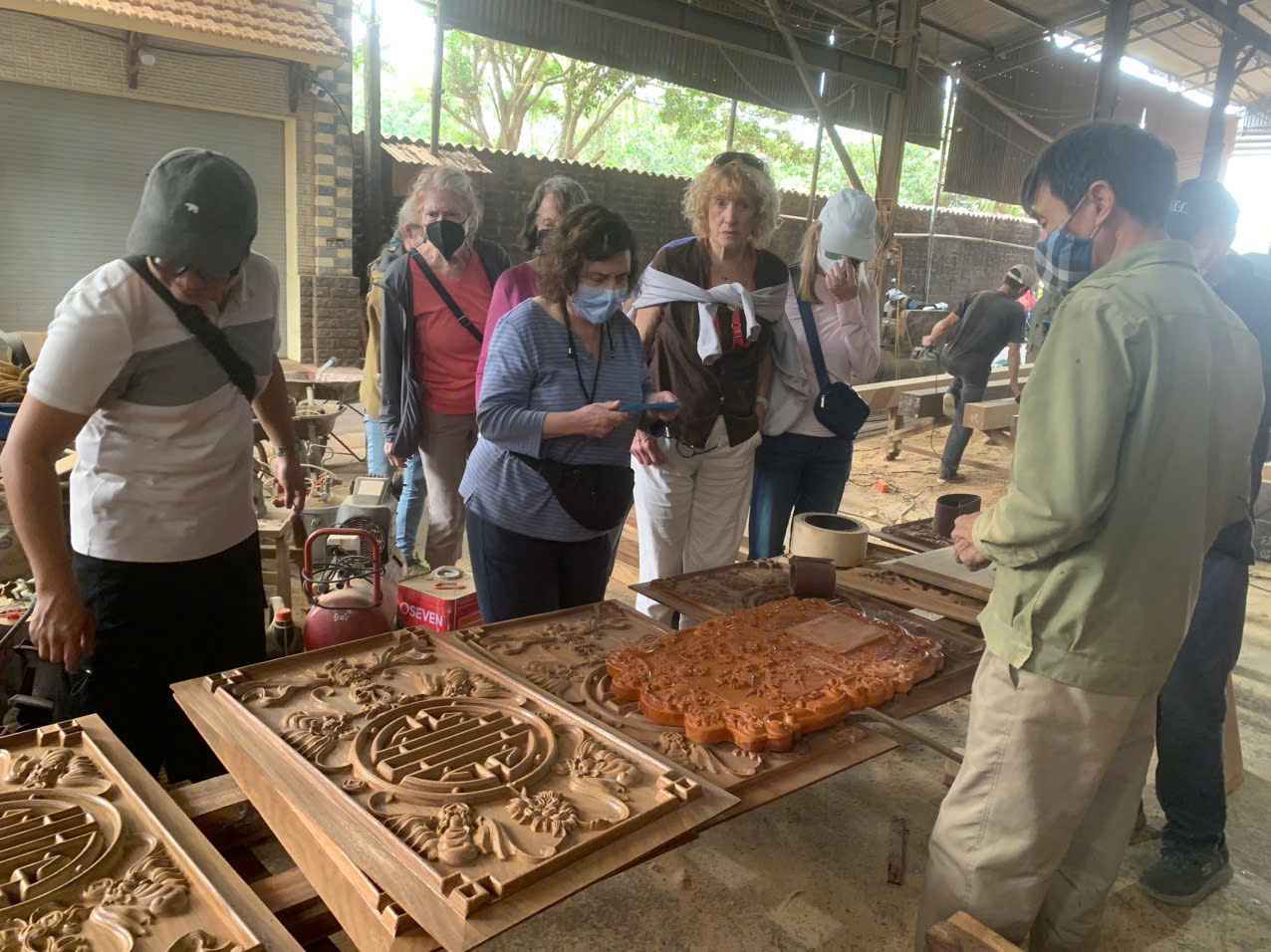 Du khách quan sát các công đoạn sản xuất thủ công tại làng nghề mộc.
