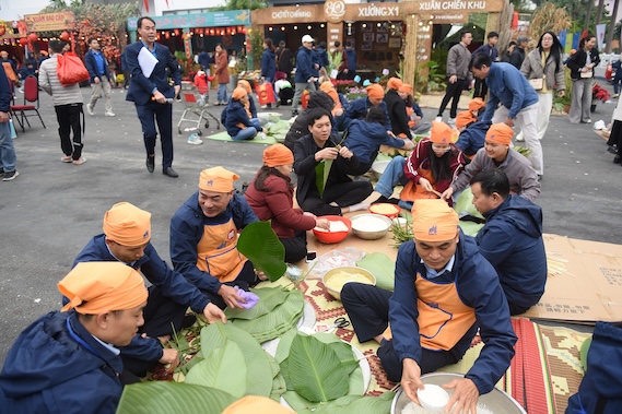 Les membres du syndicat et les travailleurs participent au concours d'emballage de bánh chưng au programme Têt Sum vầy - Printemps de la gratitude envers le Parti. Photo: CĐCT