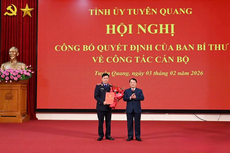 El secretario del Comité del Partido Provincial de Tuyen Quang, Hau A Lenh (a la derecha), entrega la decisión y flores para felicitar al Sr. Ly Van Huan. Foto: Tuyen Quang GOP