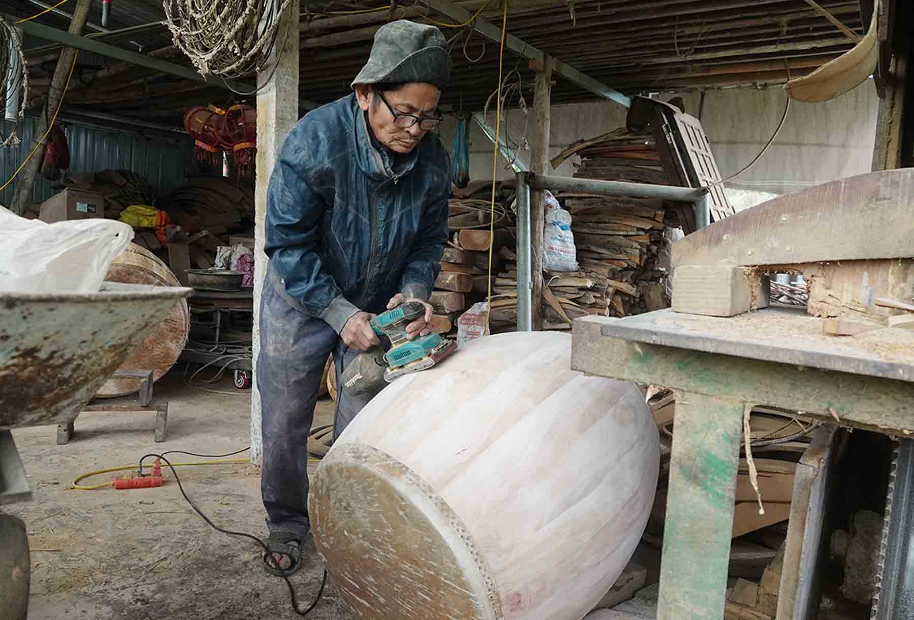 Ông Tráng bên chiếc trống sắp hoàn thiện. Ảnh: Trần Tuấn.