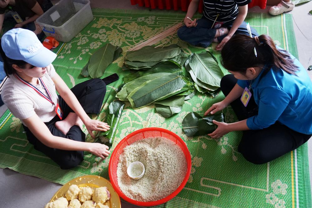 Hàng trăm công nhân lao động hứng khởi tham gia, cổ vũ các đội thi gói bánh chưng. Ảnh: Quách Du