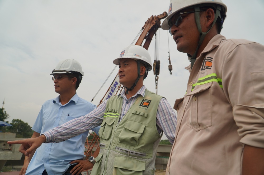 Anh Phan Hữu Thao (ở giữa) - Chỉ huy trưởng gói thầu XL5 Vành đai 3 trực tiếp chỉ đạo tại hiện trường, điều phối 3 ca làm việc 24/24 giờ để đảm bảo mục tiêu thông xe. Ảnh: Anh Tú 