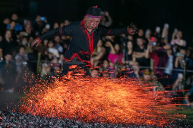 Các nghệ nhân nhảy lửa dùng tay hất lửa than, chân đá khiến than nóng đỏ bay rực trời. Ảnh: Minh Dân