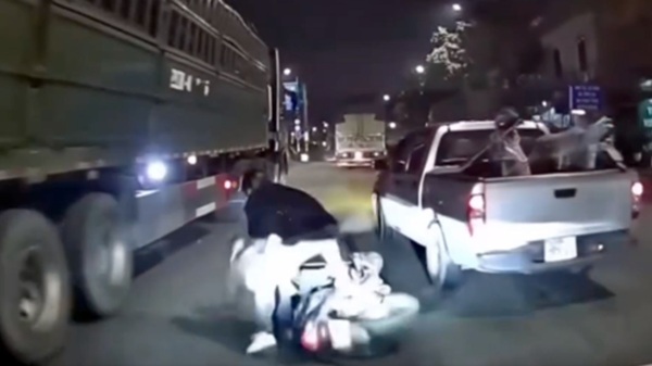 Image of a pickup truck stopping a motorbike in Hanoi. Photo cut from clip