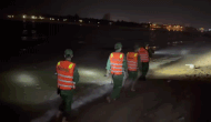 Searching for the missing man while swimming in Nhat Le beach. Photo: Quang Tri Border Guard