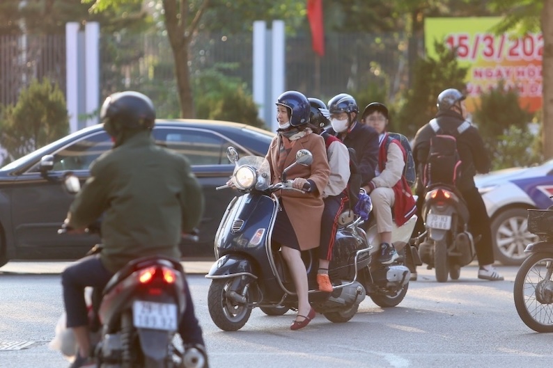 Phụ huynh chở con đi học 