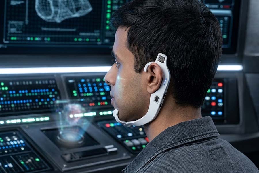 Wearable devices by a research group from MIT allow users to communicate and control digital devices without emitting sound. AI graphics: Cat Tien