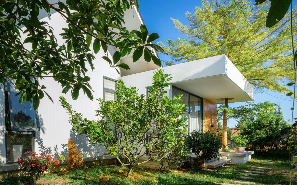 Ở các mặt Đông và Nam, nơi công trình tiếp giáp với vườn, hồ nước và hướng gió mát, hệ kính lớn được sử dụng để mở rộng tầm nhìn, tạo sự kết nối liên tục giữa khu vực sinh hoạt chung và cảnh quan bên ngoài.