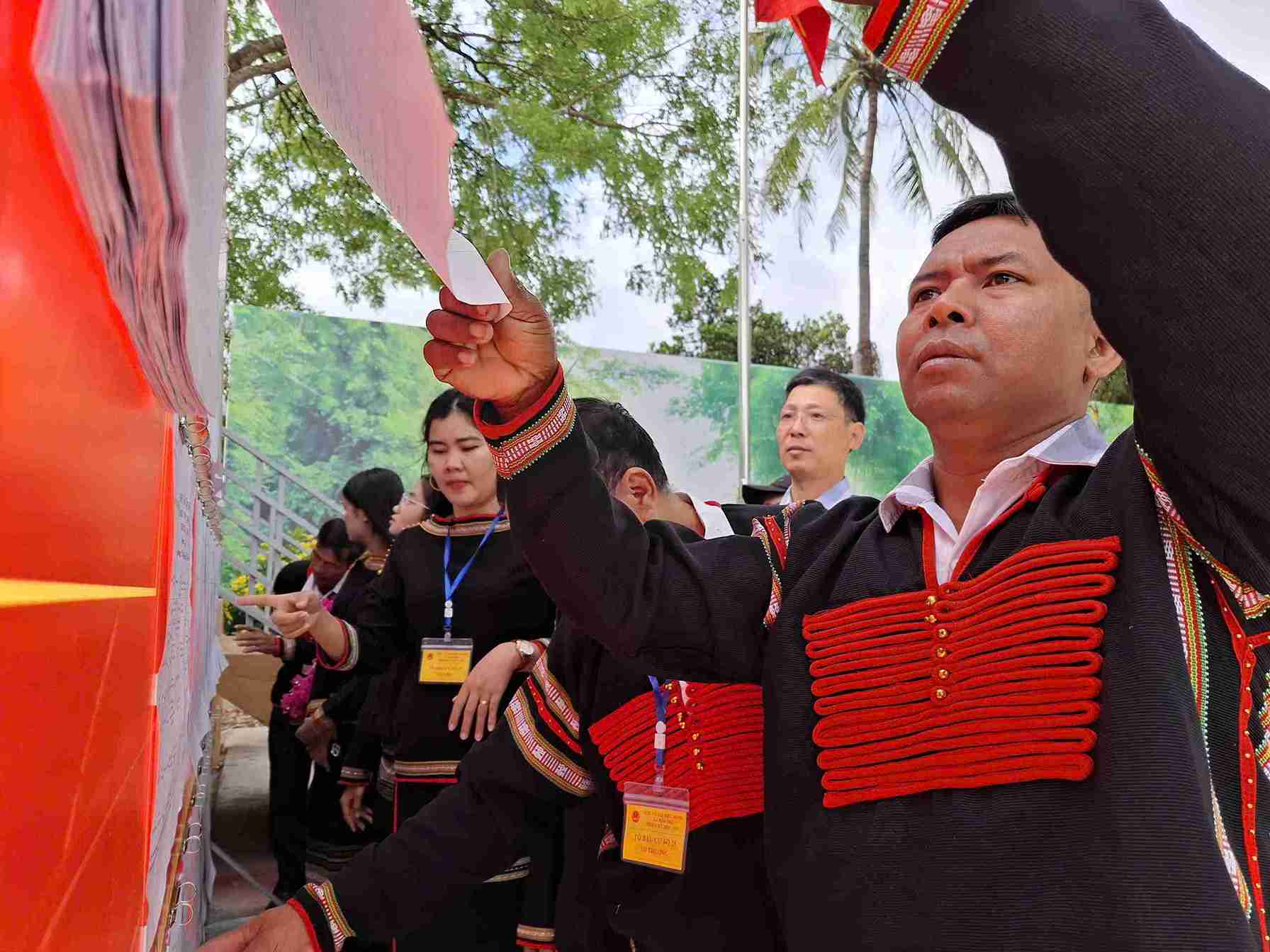 Mr. Y Thut Bya - village elder, prestigious person cum village chief in Dak Lak - carefully monitors the list of candidates before the election day. Photo: Bao Trung