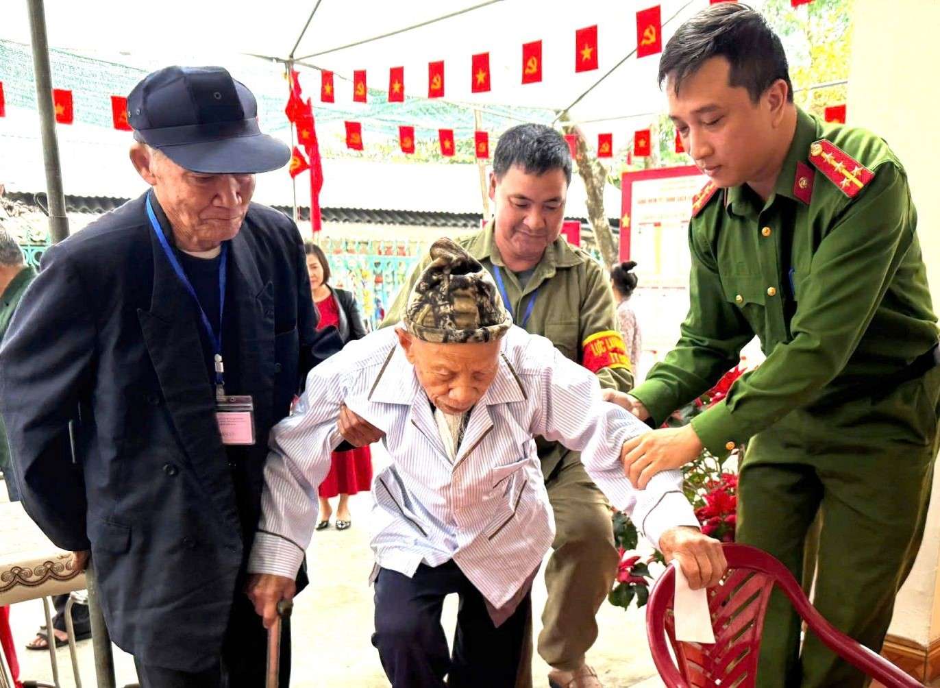 các cử tri cao tuổi đi lại khó khăn được hỗ trợ đến điểm bỏ phiếu. Ảnh: Nguyễn Trường