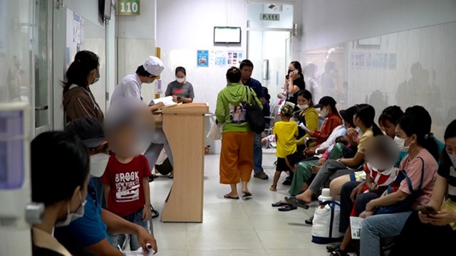 La gente de la ciudad de Ho Chi Minh lleva a sus hijos al médico, no pocos niños tienen tos prolongada. Foto: Nguyen Ly