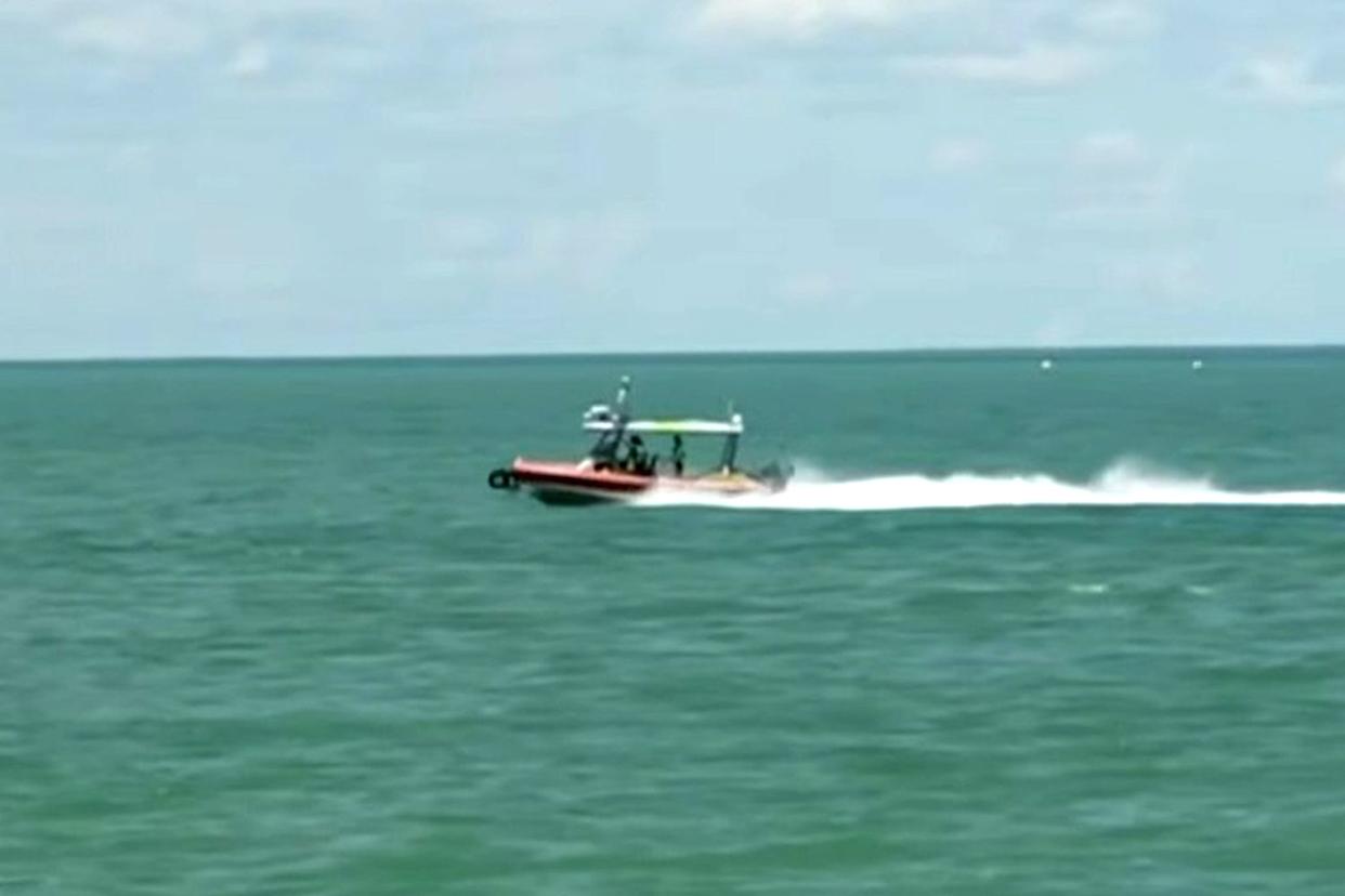 Rescue forces approach the plane crash site in Broome, a town in Western Australia (Australia) to rescue victims. Photo cut from video