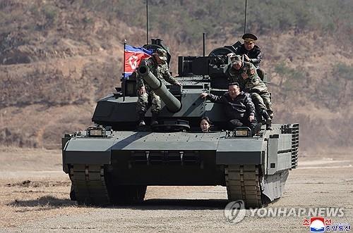 North Korean President Kim Jong Un and his daughter on a new tank. Photo: KCNA