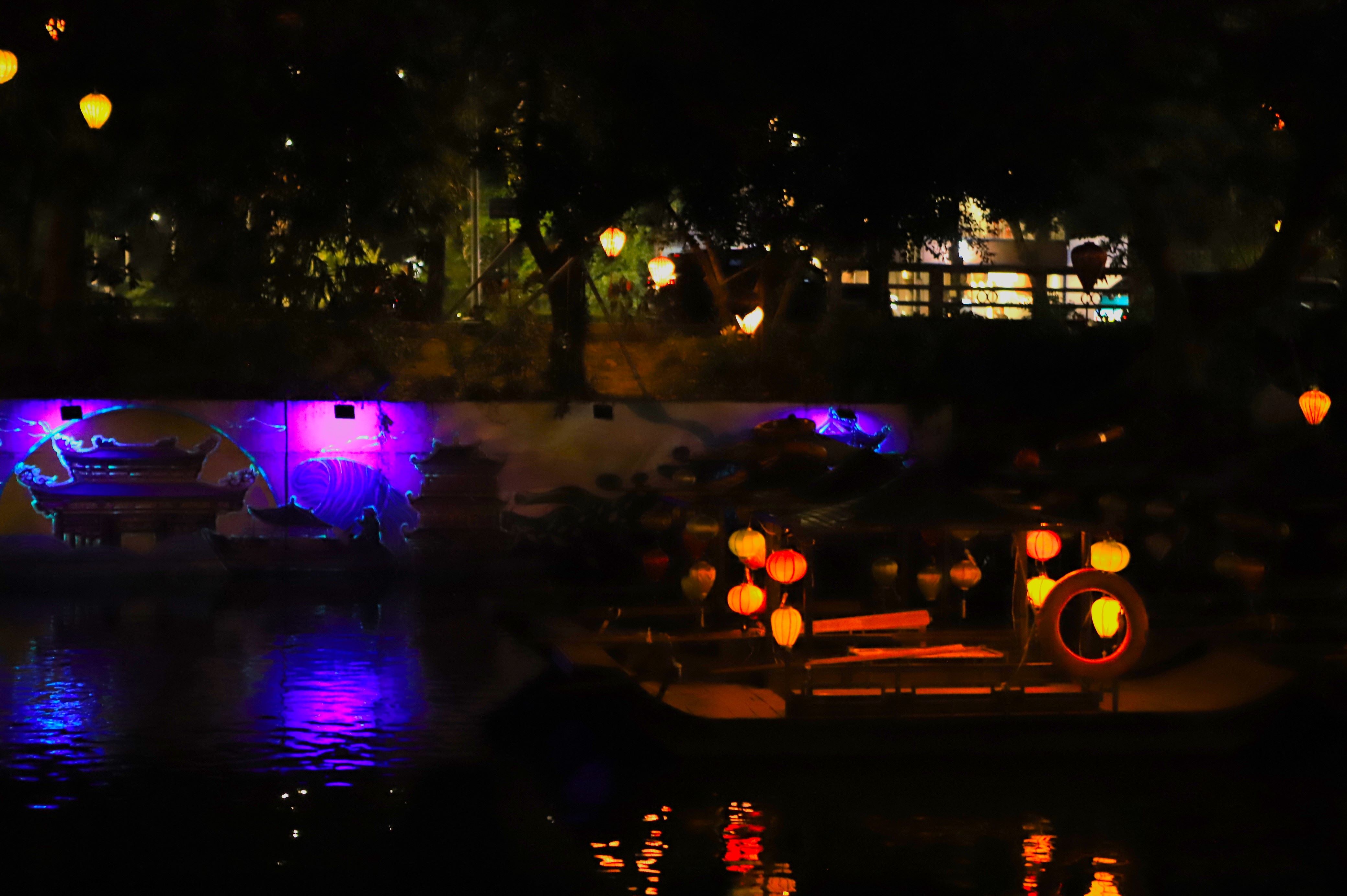 แสงไฟนีออนที่เจิดจรัสผสานกับงานศิลปะบนผนัง ทำให้ทะเลสาบกีหลานเปล่งประกายและงดงามน่าหลงใหลในเมืองโบราณฮวาหลู ภาพ: มินห์ วู