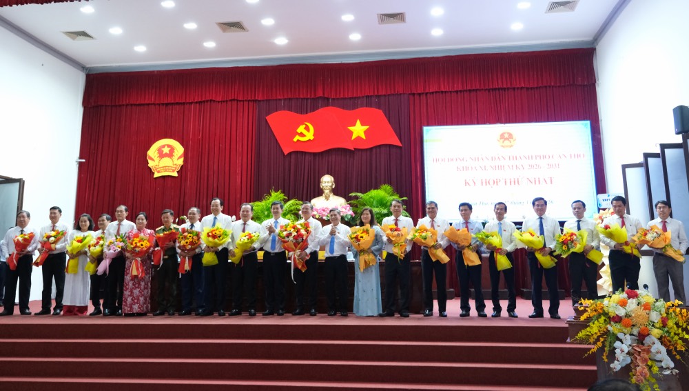 Ông Trương Cảnh Tuyên cùng các Phó Chủ tịch, Ủy viên UBND TP Cần Thơ nhiệm kỳ 2026 - 2031 nhận hoa chúc mừng từ ông Lê Quang Tùng - Ủy viên BCH Trung ương Đảng, Bí thư Thành ủy Cần Thơ và ông Đồng Văn Thanh - Ủy viên Trung ương Đảng, Phó Bí thư Thường trực Thành ủy, Chủ tịch HĐND TP Cần Thơ. Ảnh: Phong Linh. 