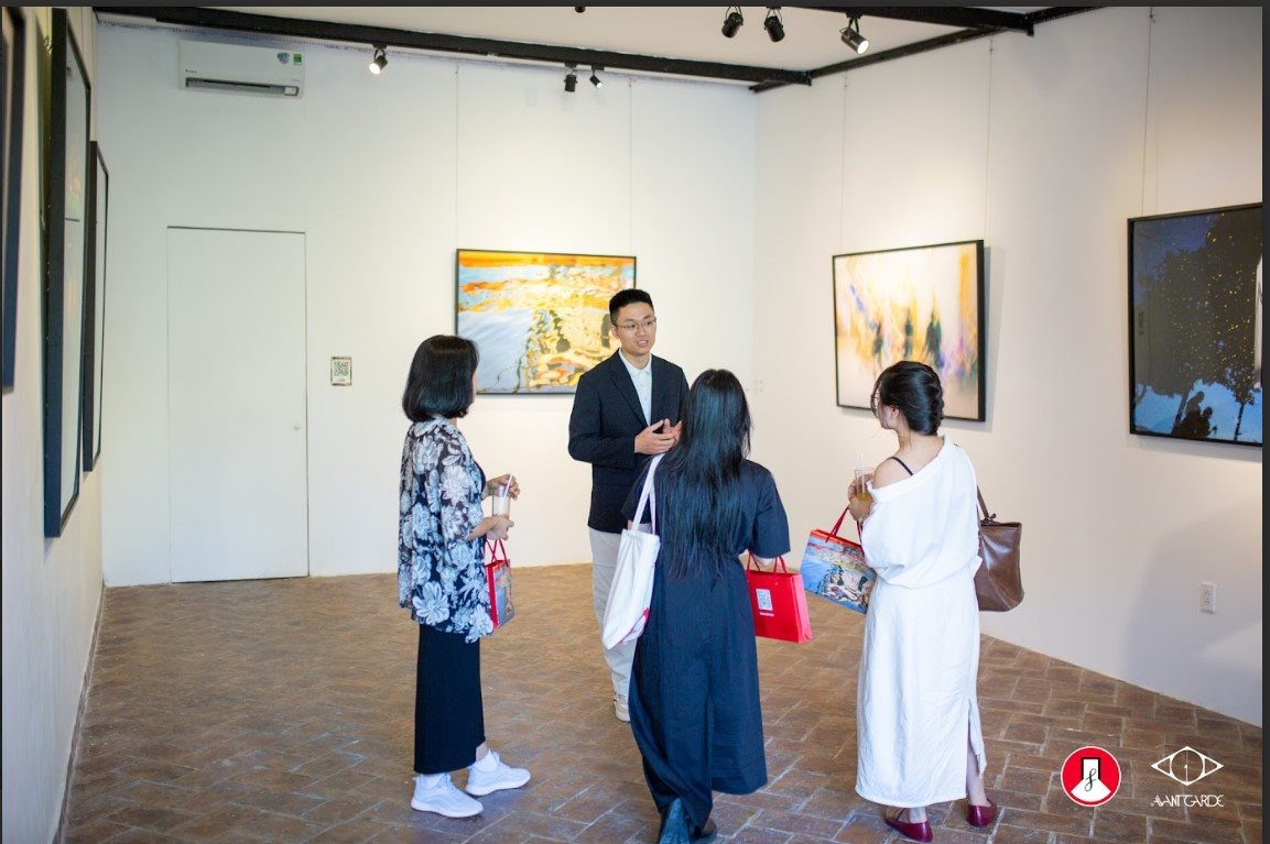 Author Tung Xuan Lam next to his photo exhibition space. Photo: Noirfoto