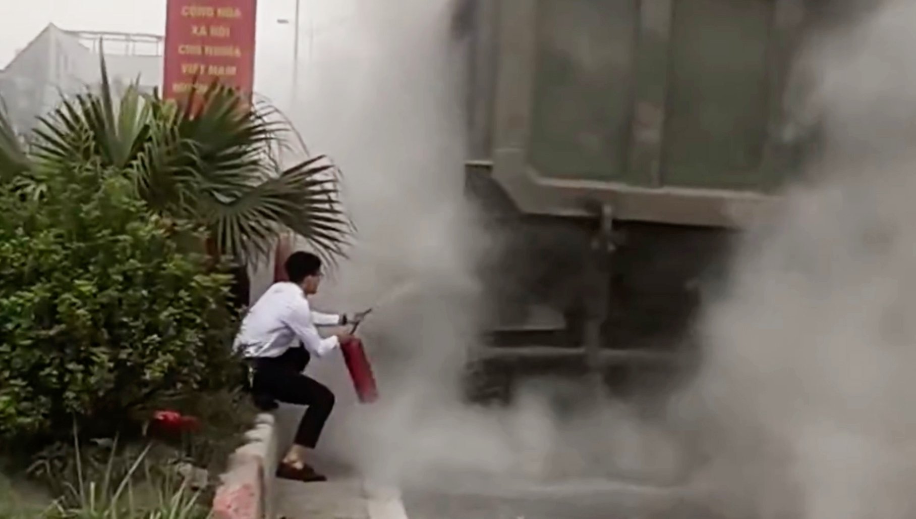 People support firefighting when truck wheels catch fire. Photo cut from clip